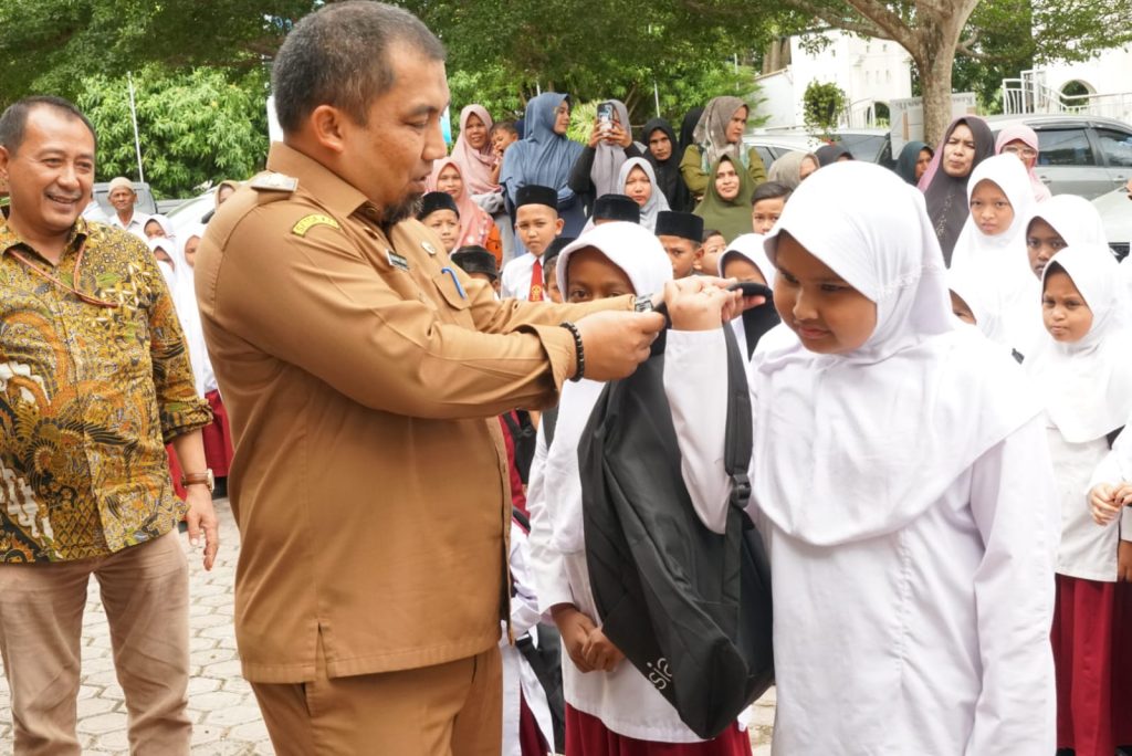 Pj Bupati Aceh Besar Serahkan 229 Paket Bantuan untuk Siswa Kurang Mampu