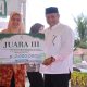 Sekda dan Ketua TP PKK Aceh Besar Serahkan Hadiah Toet Apam dan Bubur Asyura